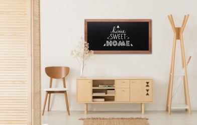 Wooden,Cabinet,With,Flowers,And,Heather,Between,Stylish,Brown,Chair Wooden cabinet with flowers and heather between stylish brown chair and wooden hanger, real photo